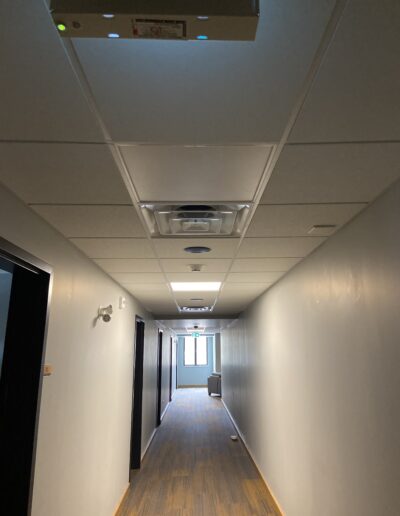 A hallway with suspended ceilings. Sound dampening ceiling panels.